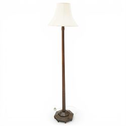 Acornman - dark stained oak standard lamp, supported on an octagonal column terminating in...