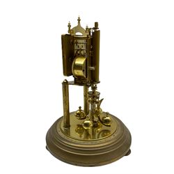 A “Kundo” 400-day torsion clock made by the 20th century German manufacturer Kieninger & Obergfell, with a  decorative square dial and pierced steel hands within a foliate bezel, on a circular base with adjustable feet, four-ball rotary pendulum under a glass shade. 
H30cm
