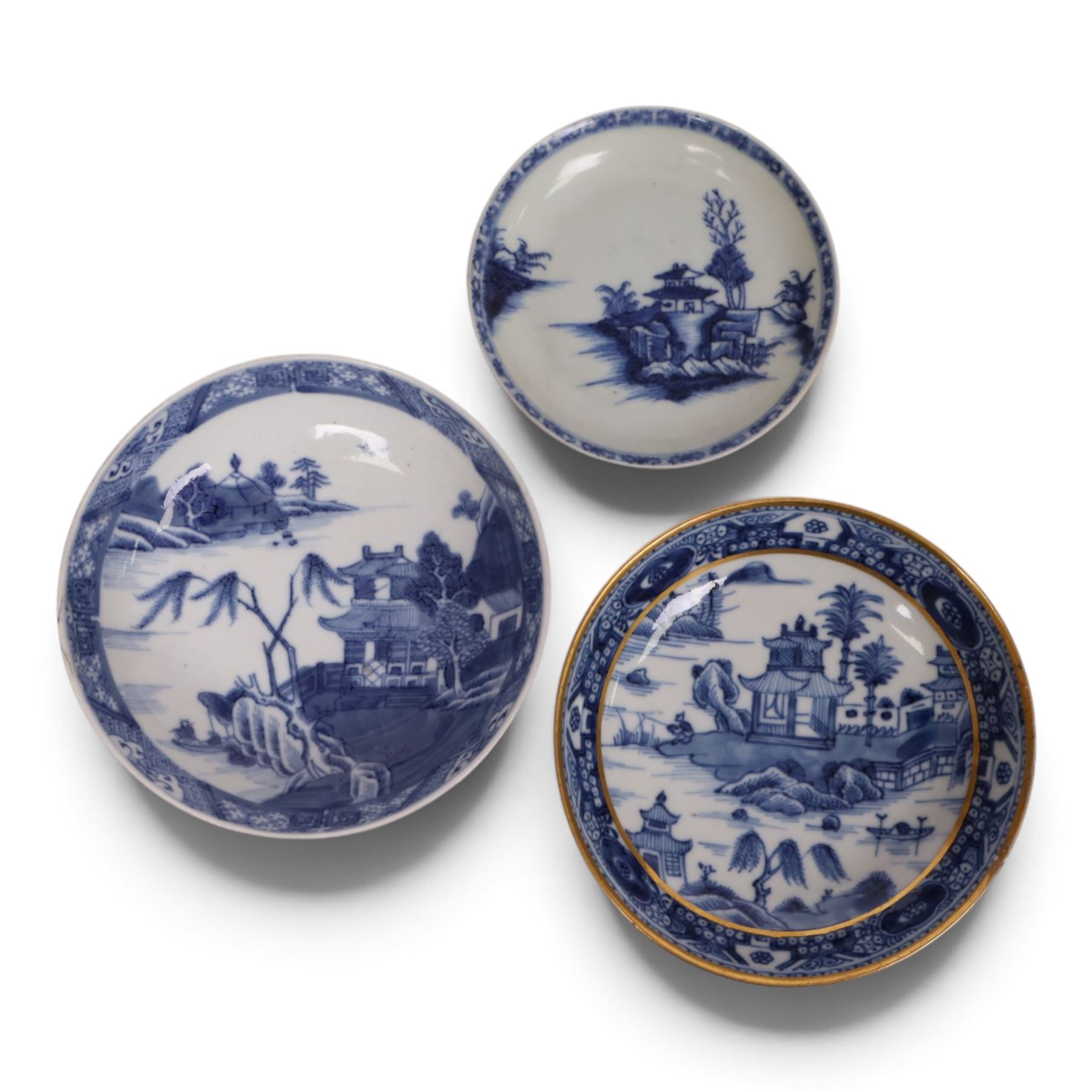 18th century Chinese blue and white ‘Nanking Cargo’ tea bowl and saucer, painted with pagoda in a landscape, with Christie's lot label No 5110, together with another tea bowl with similar decoration and gilt detail and other blue and white
