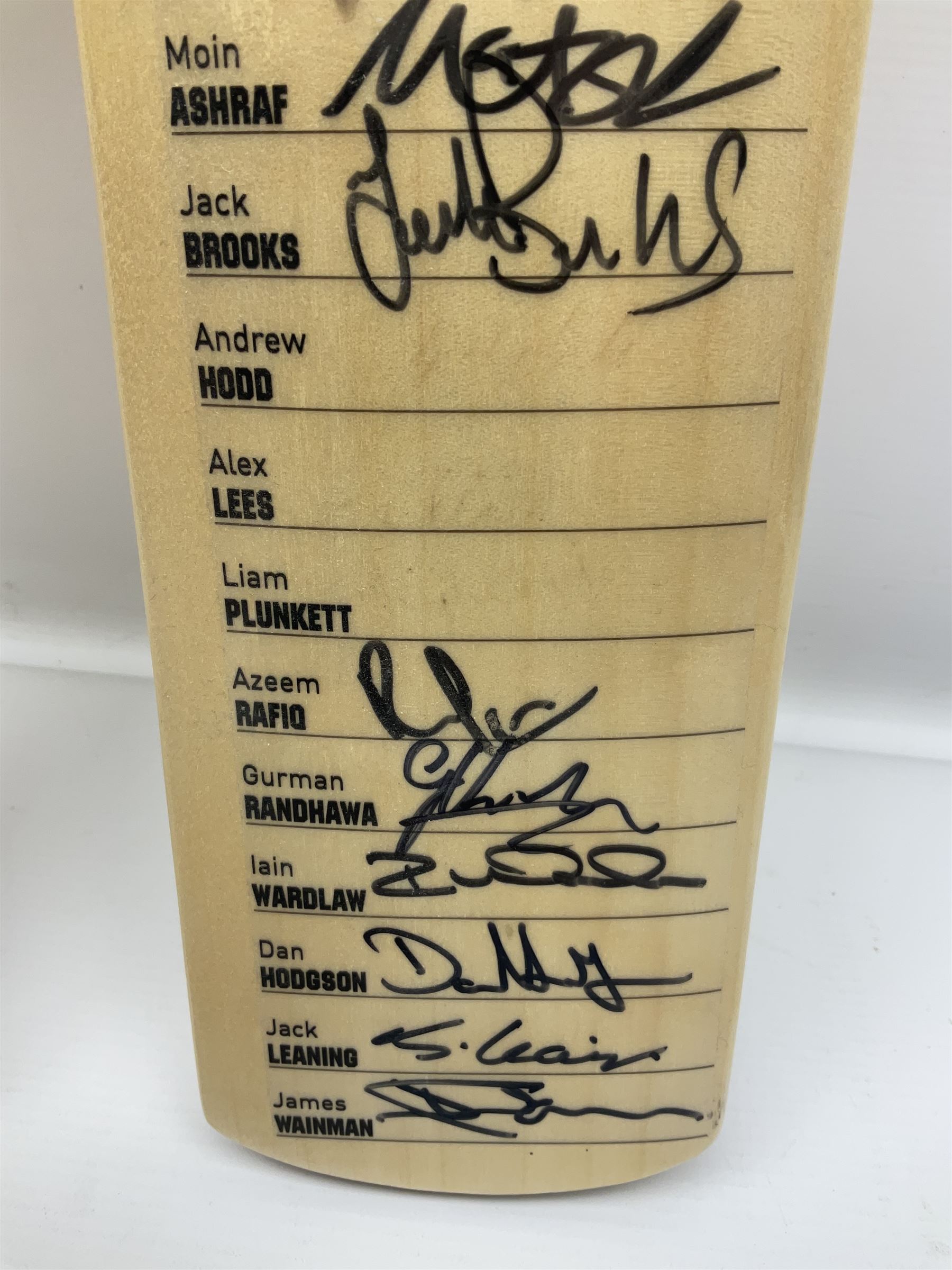 Two signed Yorkshire County cricket bats, from 2013 and 2014 seasons, bearing signatures including Johnny Bairstow, Joe Root, Tim Bresnan, Andrew Gale, etc