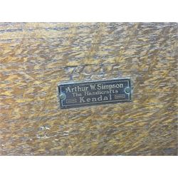 Arts and Crafts oak stand by Arthur Simpson of Kendal, of rectangular form with central hammered pewter panel, surrounded by a border with carved foliate corners, upon two bar supports, bearing label detailed 