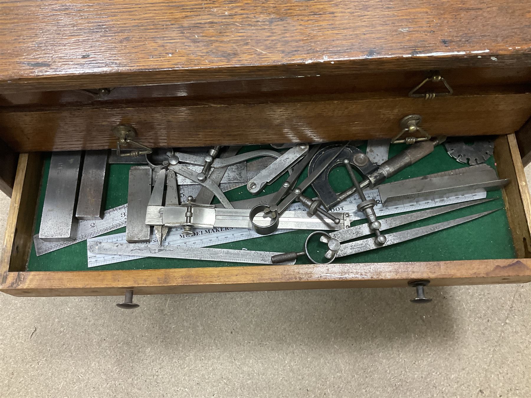 Six shelved cabinets for displaying ‘00’ gauge locomotives comprising plain plywood and white painted examples with track applied to various shelves, largest H63cm, W107cm, D27cm; Collection of tools for building model locomotives to include Weller PU-2D Soldering Pencil and Standard Tip Soldering Iron 20W/230V, Humbrol Modellers Airbrush, Power Supply Units and two wooden chests one of which housing a collection of tools including tweezers, scalping tools, wrenches etc 