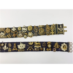 Collection of Glengarry and cap badges, shoulder titles, collar dogs, buttons etc mounted on two military belts, including rare Kitchener's Army Volunteer Training Corps Surrey 1915, two Ulster Volunteer Force (L6521 & L2007), Royal Irish, North Irish Horse, Inniskillings, Royal Irish Rifles, London Irish, London Irish Rifles, Royal Irish Fusiliers, Queen's Own Cameron Highlanders, Royal Scots, 9th Battalion (Glasgow) HLI, Royal Welch Fusiliers, South Wales Borderers, Church Lads Brigade, various regiments and corps, RUC and officer's training corps buttons etc
