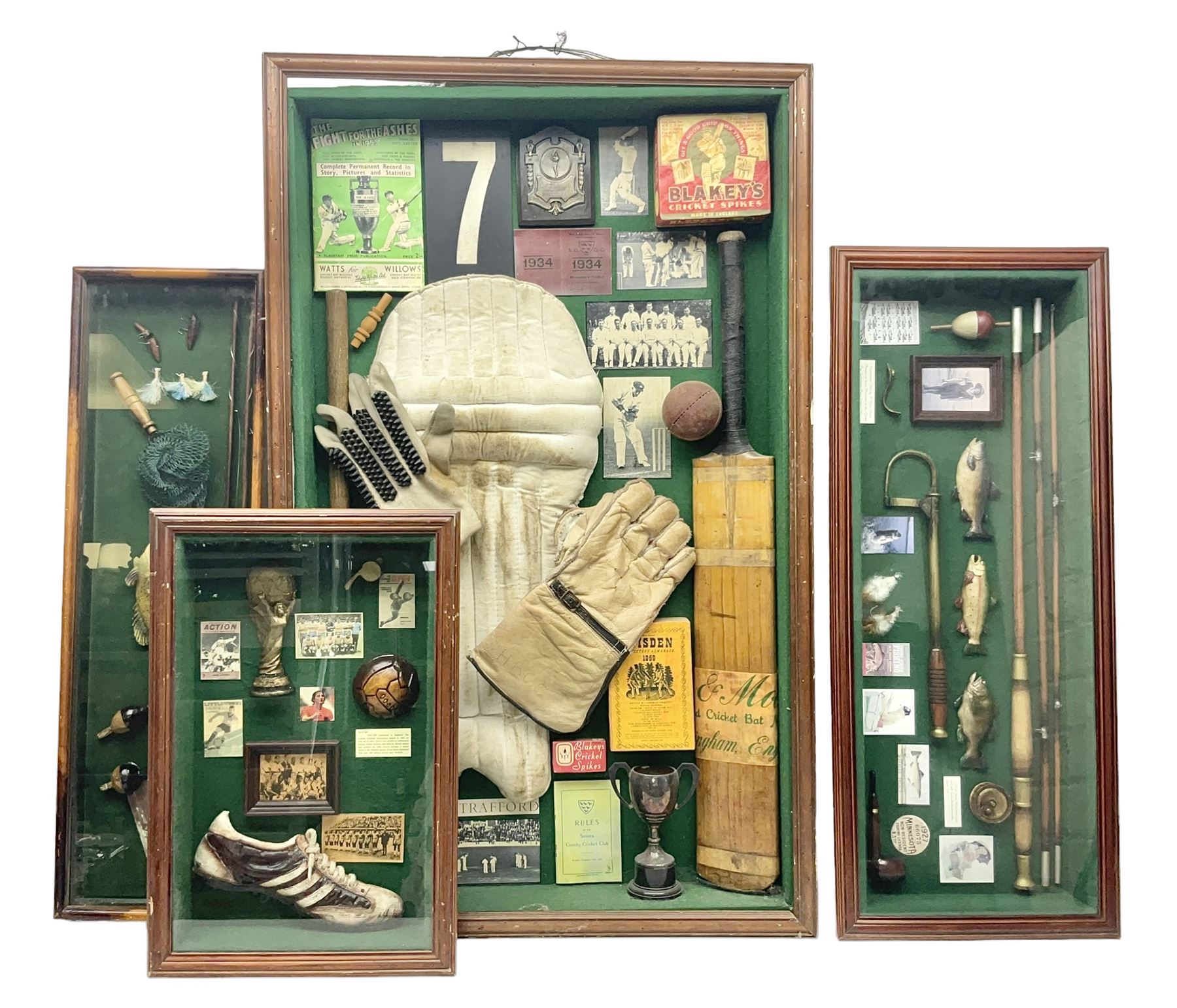 Four framed sporting memorabilia displays, the largest example containing 1930s cricket memorabilia, together with two fishing displays and a football display, each within wooden glazed frames, largest H105cm