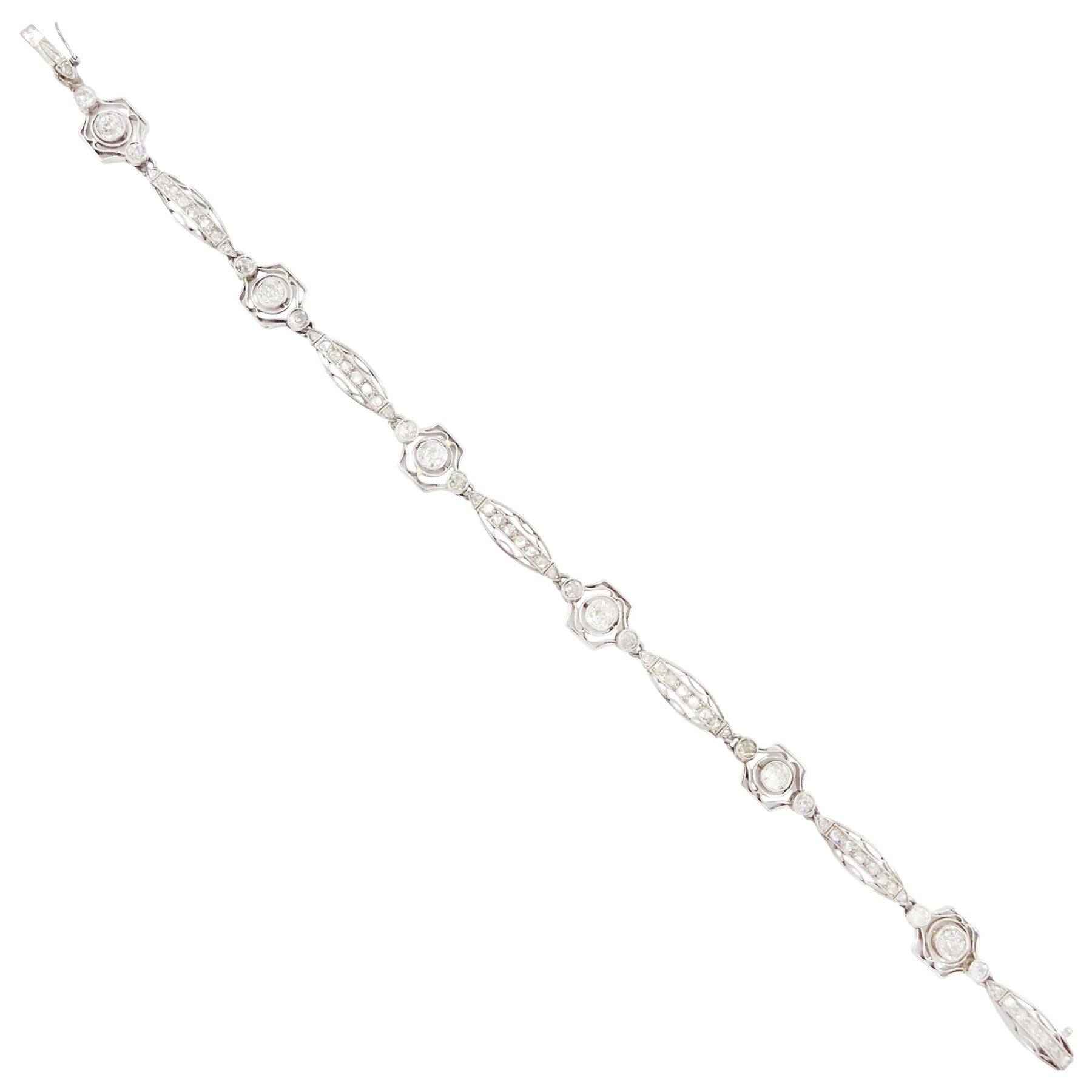 Art Deco French platinum diamond bracelet, six pierced design navette shaped links, set with rose cut diamonds, each spaced by three old cut diamonds, milgrain set in a pierced fancy hexagonal setting, dogs head hallmark, total diamond weight approx 2.00 carat