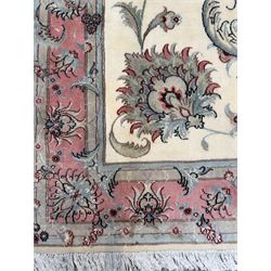 North East Persian Kashmar hand-knotted rug, ivory field with an all-over design of linked floral medallions and scrolling vines with a central circular medallion enclosed by multiple borders and a main broad madder field with palmettes and arabesques, 248cm x 145cm