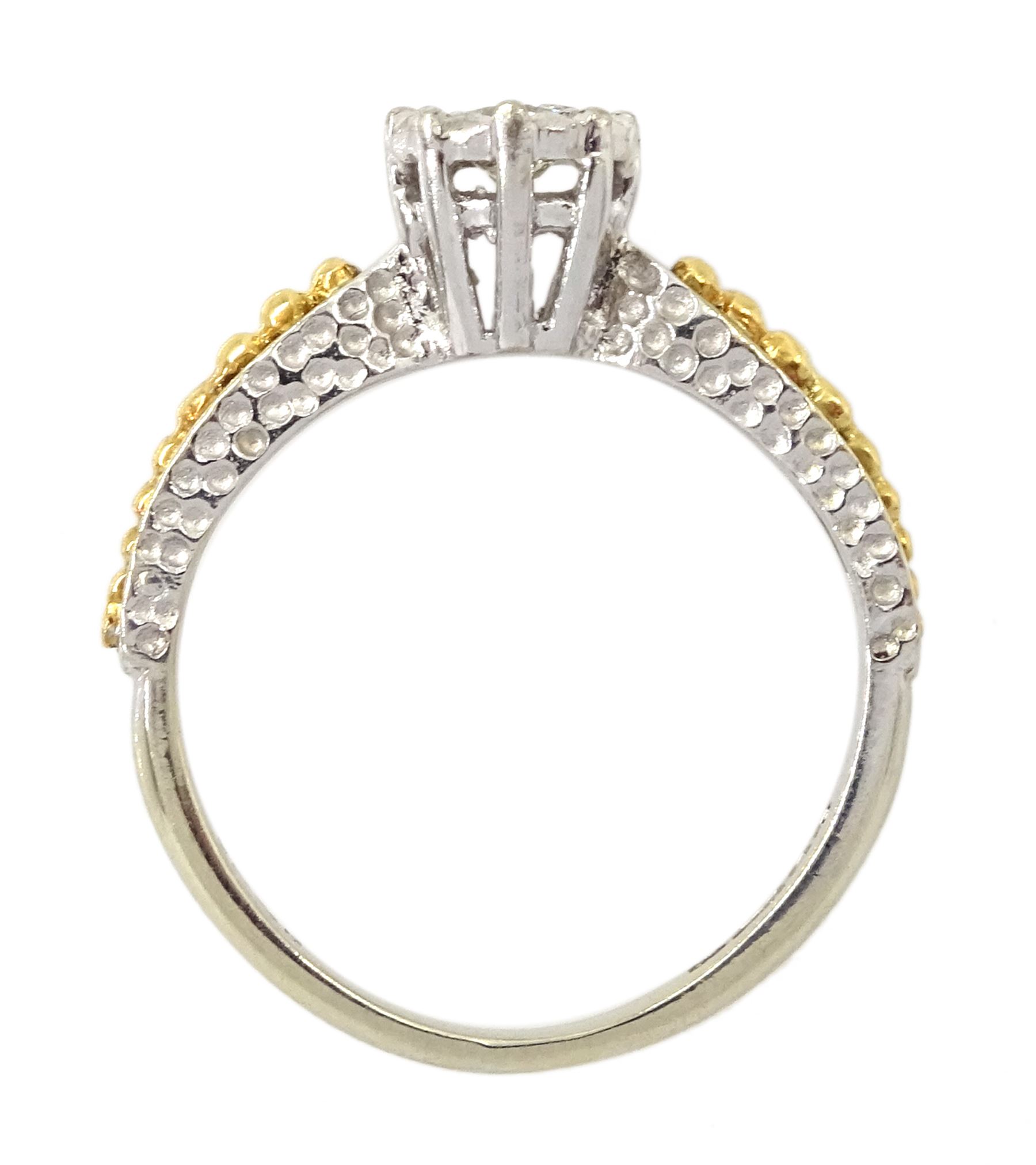 18ct white gold single stone diamond ring, with yellow gold bead design shoulders, London 1979, diamond approx 0.15 carat