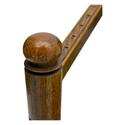 19th century swedish monk's chair, the oak frame with triangular seat and sloped arms, the backrest carved with geometric chipwork and a central pierced medallion 