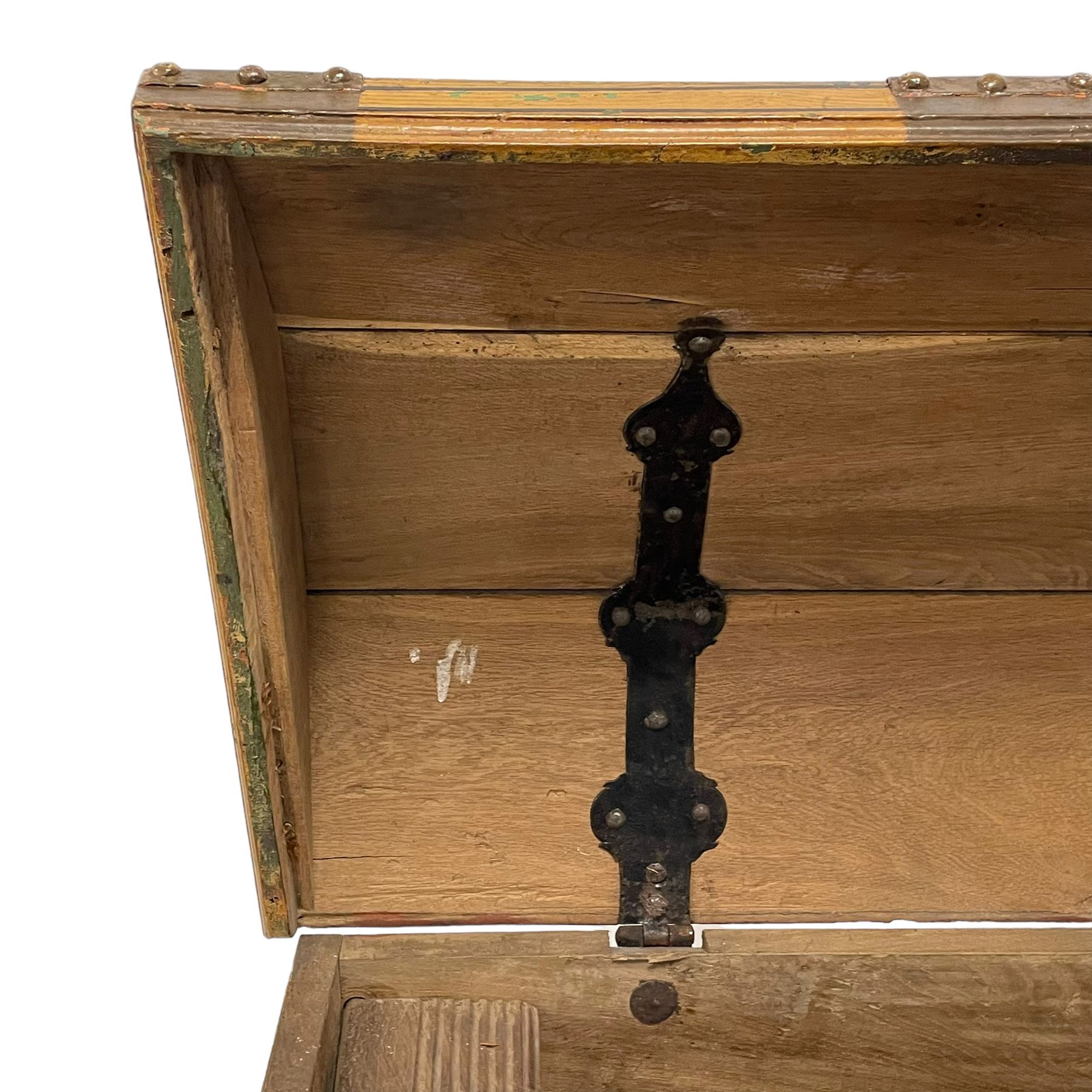 19th century painted oak sea chest, hinged dome top enclosing small compartment, bound by shaped and pressed metal strapwork, scumbled finish to resemble oak and painted with small vignettes depicting portraits and landscapes within panels, fitted with large wrought metal carrying handles, the front inscribed 'H.J.S. 1870' 