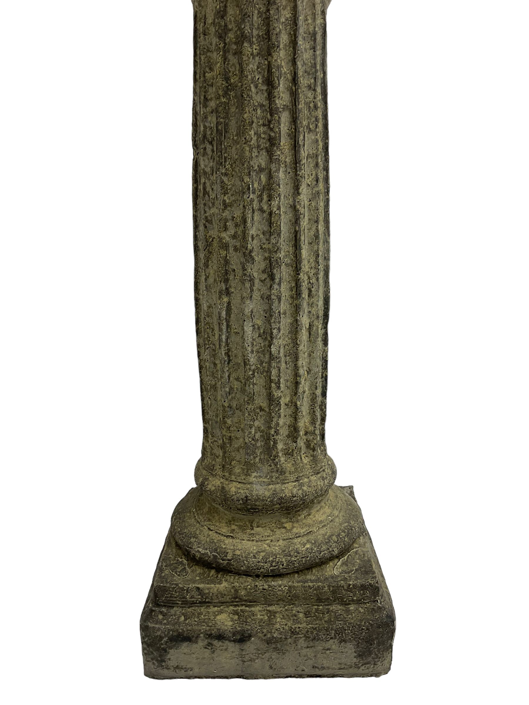 Classical design cast stone female bust depicting Artemis, raised on fluted Corinthian column with acanthus leaf capital, stepped square base, looking right 