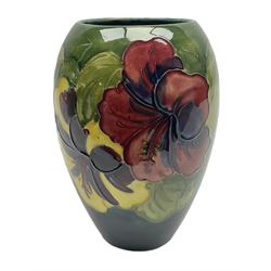 Moorcroft Hibiscus pattern vase of ovoid form, decorated with pink, yellow and purple flowers on merging blue and green vase, with impressed and painted marks beneath, H18cm