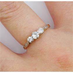 18ct gold three stone round brilliant cut diamond ring, with diamond set shoulders, total diamond weight approx 0.35 carat