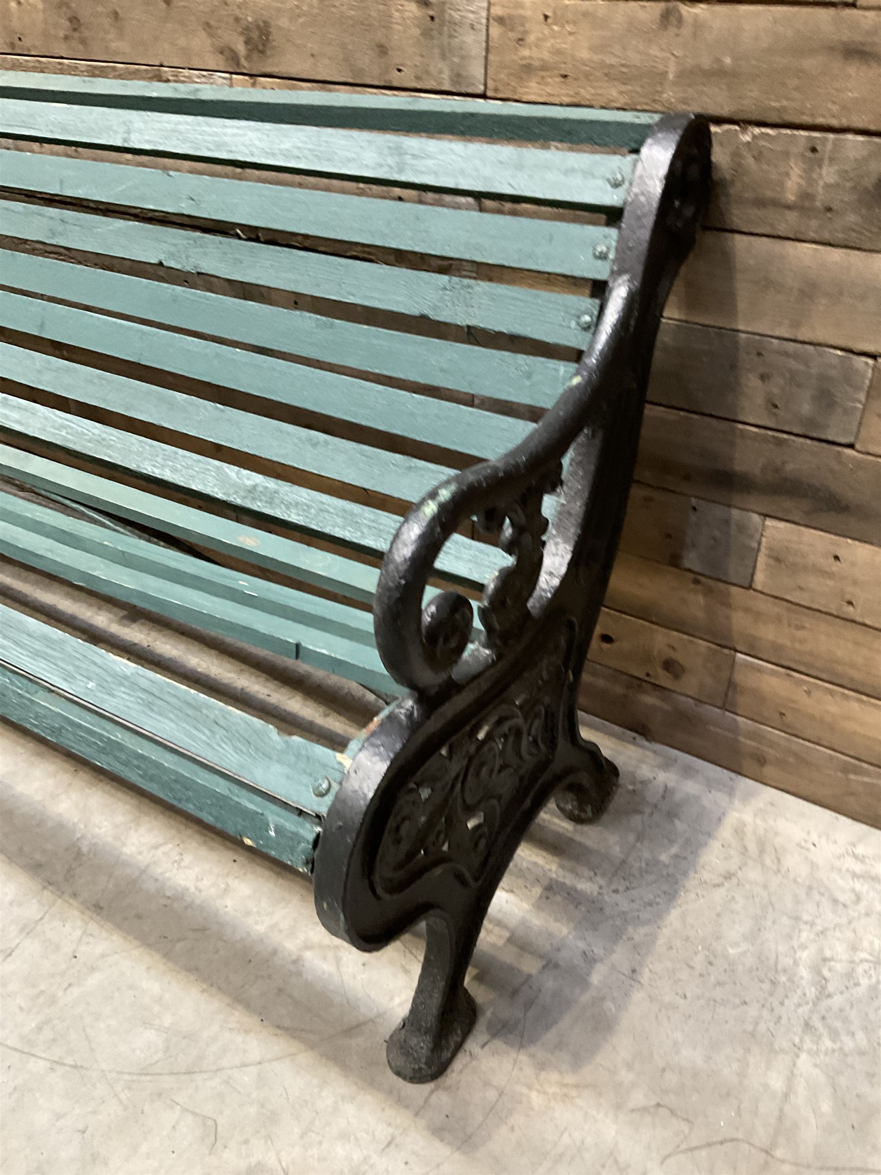 Early 20th century slatted garden bench with scrolling cast iron bench ends