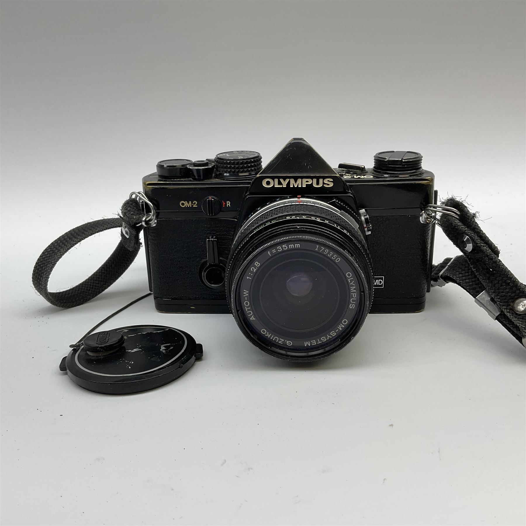 Olympus OM2 camera, 'no.264258', fitted with Olympus 'OM System G.Zuiko Auto-W 1:2.8 f35mm' lens and two other lenses, in a carry case