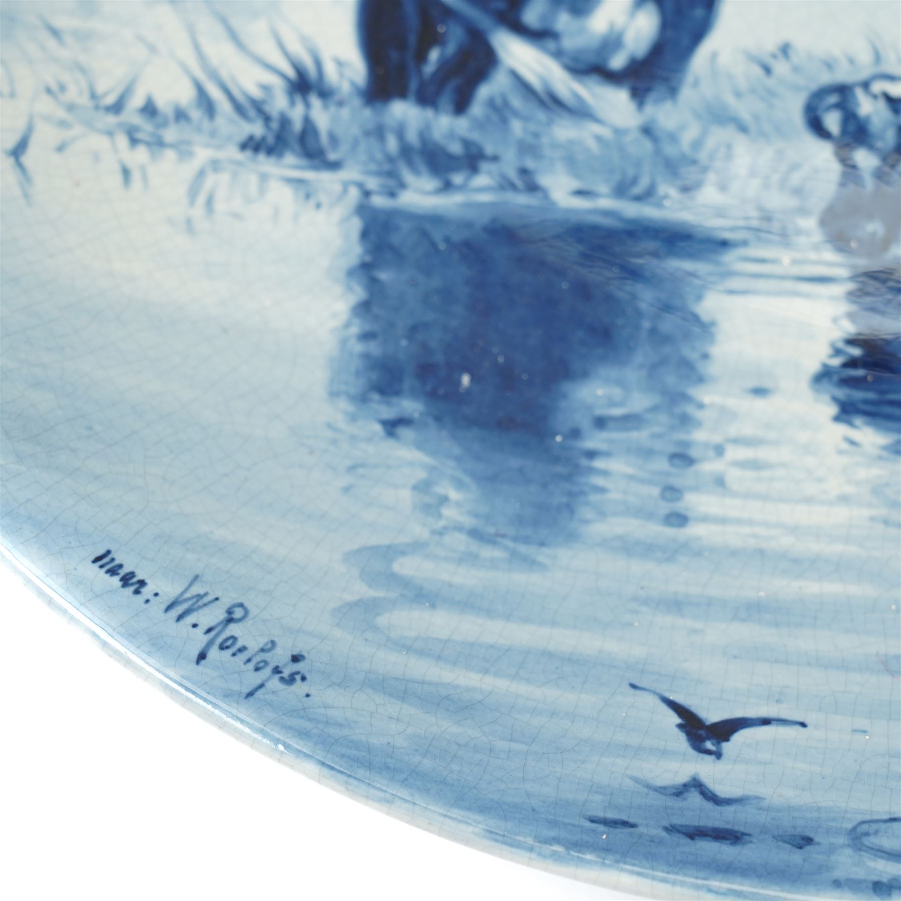 Continental figural group of two owls, possibly by Ernst Bohne & Söhne, modelled in a naturalistic setting, H25cm; together with a model delft charger (2)