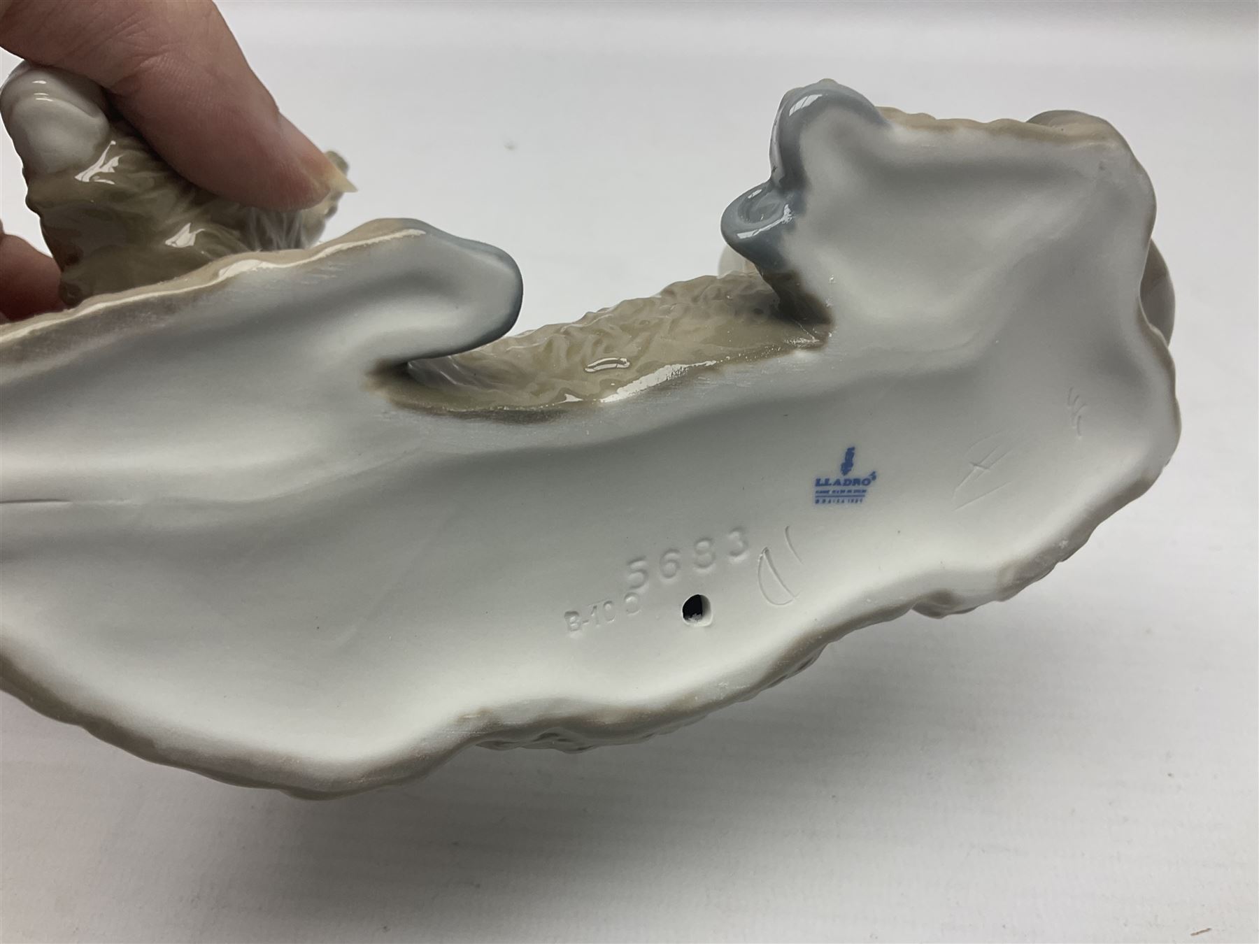 Lladro figures of animals, comprising Mini Lion no 5436, Beautiful Burro no 5683, Hawk Owl no 5422, Beagle Puppy Sitting no 1071, Duck Flying no 1264, Miniature Cat no 5308 and Small Papillon Dog no 4749, four with original boxes, largest example H14cm