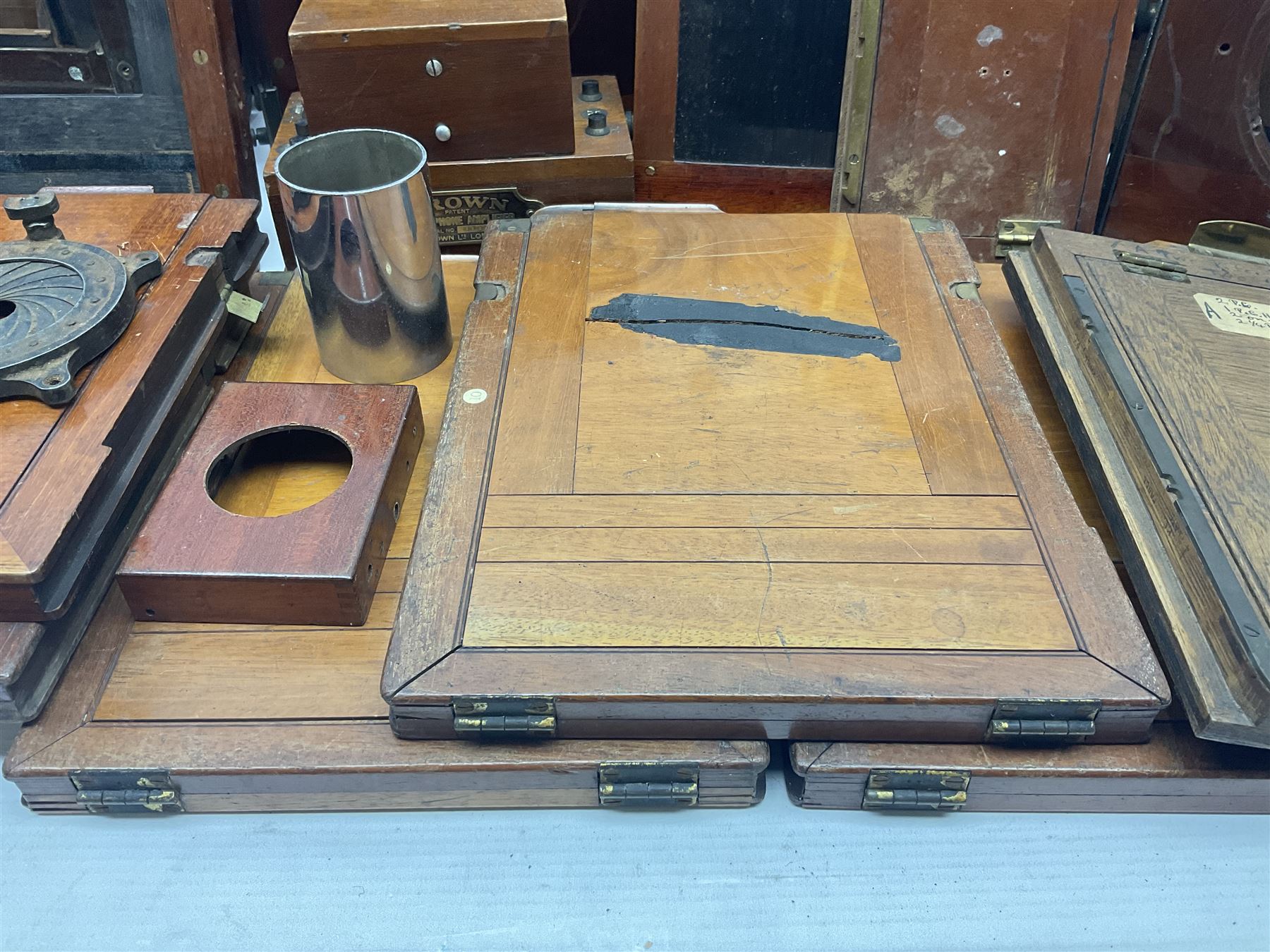 Collation of folding plate cameras of various sizes folding plate in mahogany and lacquered brass, together with camera plates and slides
By vendors repute some slide are from the Gandolfi workshop