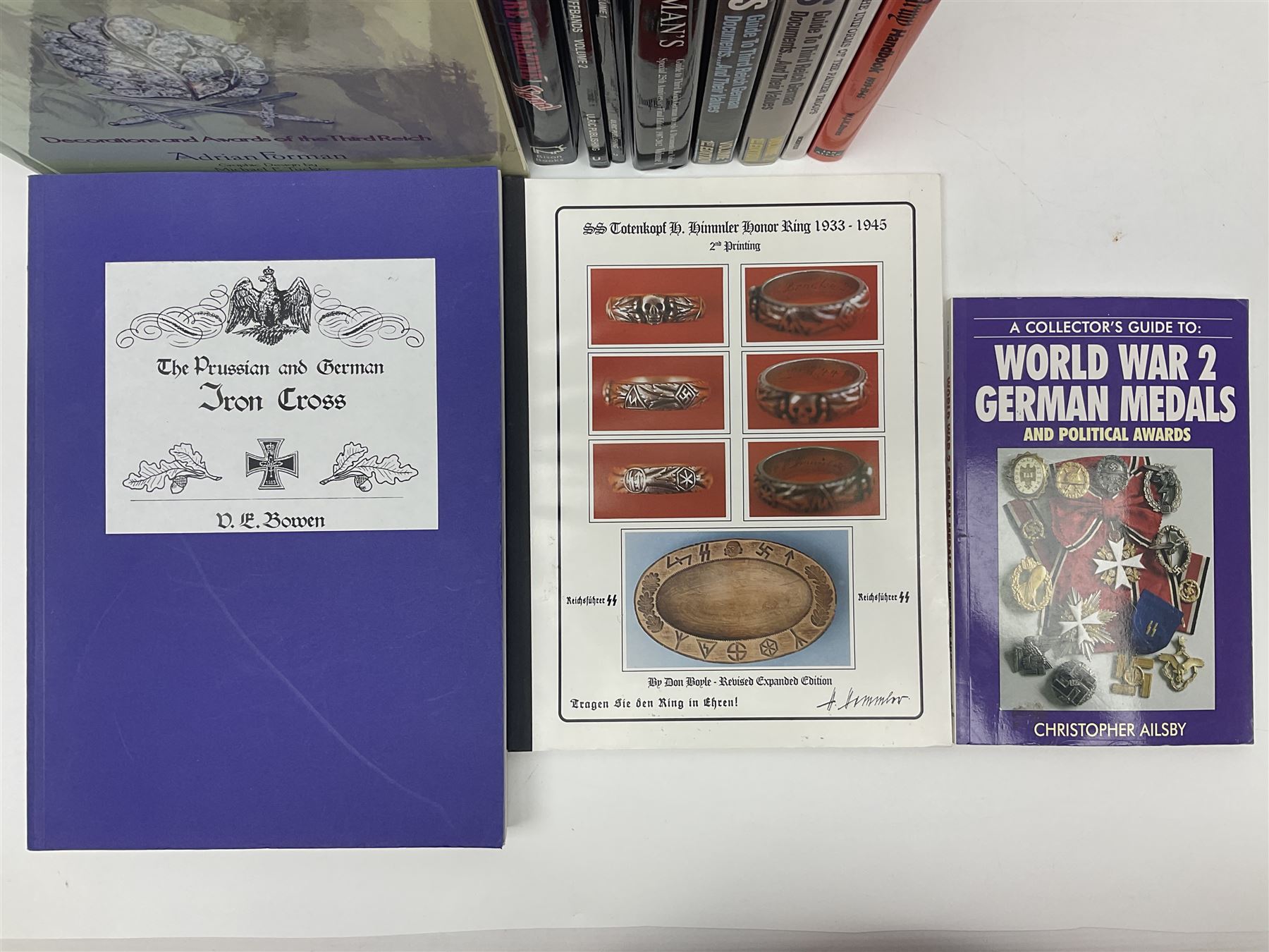 Excellent collection of twelve German Third Reich reference books including four by Adrian Forman - Guide to Third Reich German Awards and Documents, ........ Documents and Their Values. Volumes one and two. Both limited edition and signed by the author; and Bravery, Courage & Valour - Decorations and Awards of the Third Reich; D.E. Bowen: The Prussian & German iron Cross. Signed by the author; Ulric of England: Collecting Third Reich 'SS' and Political Cuffbands. Two volumes; Don Boyle: 'SS' Totenkopf H. Himmler Ring 1933-1945. 2nd printing. Signed by the author and inscribed to 'Adrian' (Forman); and four others (12)