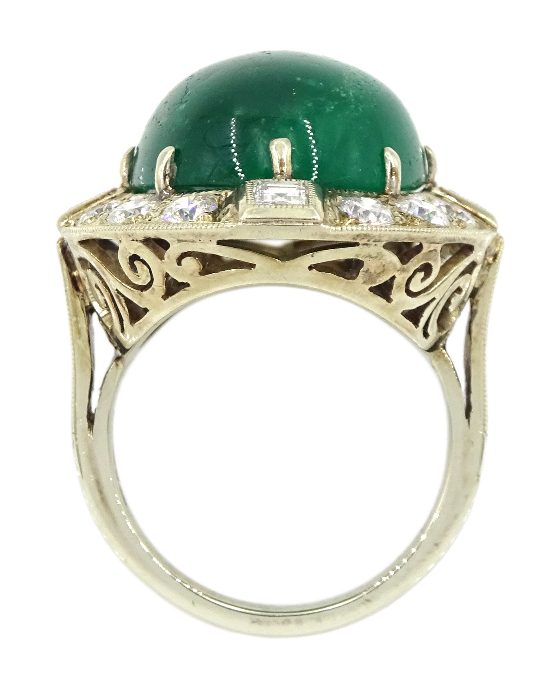 Gold emerald and diamond ring, the central oval cabochon emerald, with sixteen round and rectangular cut diamond halo surround by Judith Crowe, hallmarked 9ct, emerald 20.00 carat, total diamond weight 2.00 carat, with World Gemological Institute report