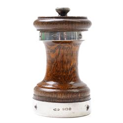 Silver napkin ring with engraved decoration and silver mounted oak pepper mill