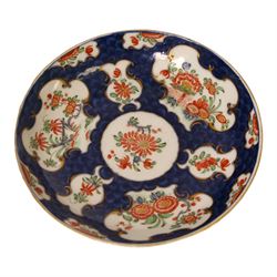 18th century Worcester coffee cup and saucer, circa 1770,  painted with shaped panels of chrysanthemums and banded hedges on a blue scale ground with gilt detail to the rim, mark beneath, H8cm 