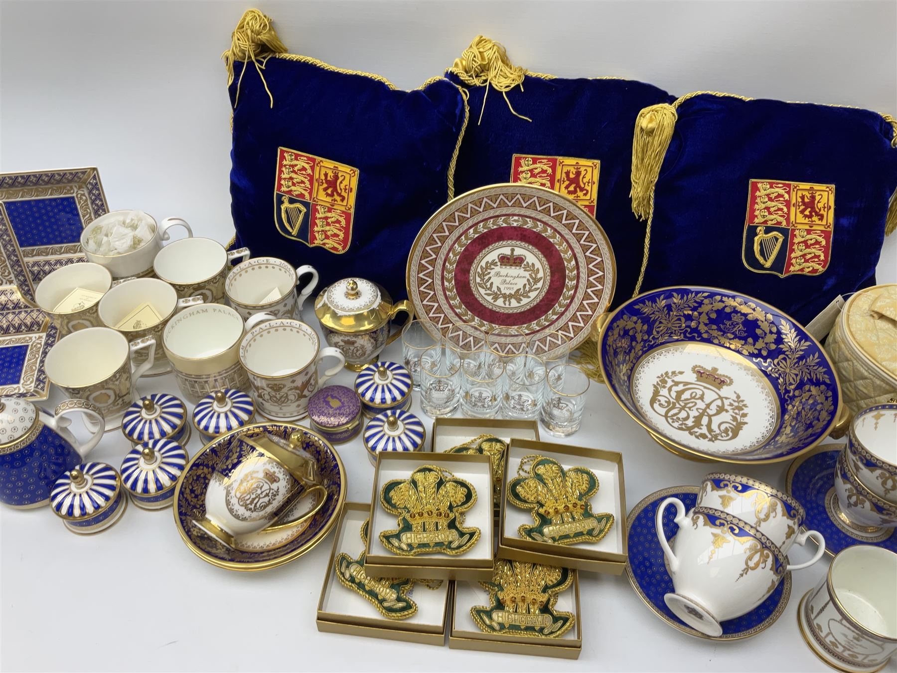 Commemorative ware Including five green and gold Highgrove limited edition hand embroidered tree decoration, a collection of ceramic ware from the royal collection including four cups and saucers, small teapot,    three trinket trays, five trinket pots with lids, eight tot glasses, three William Edwards Queens 80th cup, Hudson & Middleton hinged box etc. 