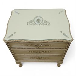 French design cream painted three drawer commode, shaped front with floral garland appliqués, fluted uprights and acanthus carved cabriole legs terminating in scroll feet