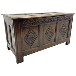18th century oak coffer or chest, rectangular triple panelled hinged top with moulded edge enclosing main compartment and candle box, the frieze carved with repeating concentric lunettes and foliate patterns, the front fielded panels decorated with lozenges containing central flower heads, on stile supports