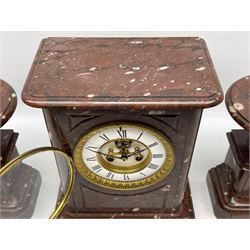 Late 19th century French mantle clock with conforming Tazzas, rectangular flat-topped case in white flecked rouge marble with incised panels, seated on a stepped plinth with an ogee moulding, eight-day countwheel striking movement striking the hours and half-hours on a bell, 4-1/2” two-piece enamel dial with Roman numerals, minute markers and steel Fleur di Lis hands, visible Brocot deadbeat escapement with jewelled cornelian pallets, within a cast brass bezel with a flat bevelled glass and egg and dart slip. With pendulum. 
Case H35 W26 D16     Tazzas H26  Dia18


