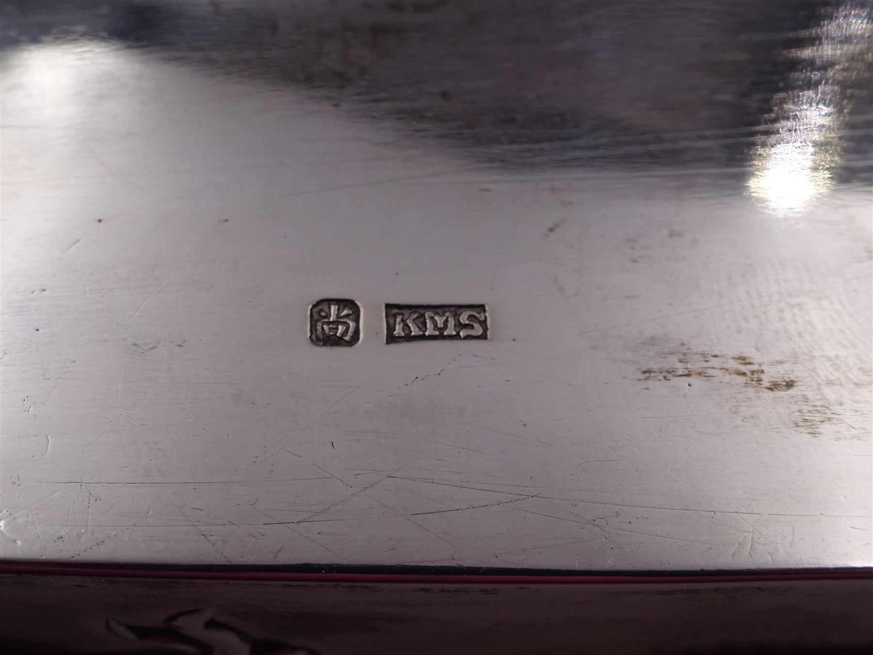 Late 19th century/early 20th century Chinese export silver mounted cigarette box, of rectangular form, decorated in relief with dragons, the hinged cover with similar dragon decoration and central blank oval cartouche, opening to reveal a softwood lined compartmentalised interior, stamped beneath with character mark and KMS for maker Kwong Man Shing, H6.3cm, W15.5cm, D9.5cm