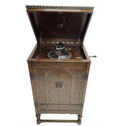 Early 20th century ‘HMV' 202 cabinet gramophone, oak cased, moulded top with foliate carved moulding hinges to reveal gramophone, two doors enclosing horn, on turned supports joined by moulded stretcher rails