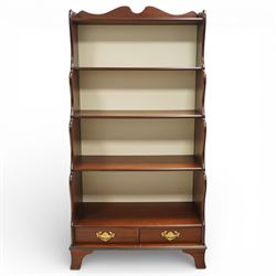 Early 20th century mahogany waterfall bookcase, shaped and serpentine side uprights with s...