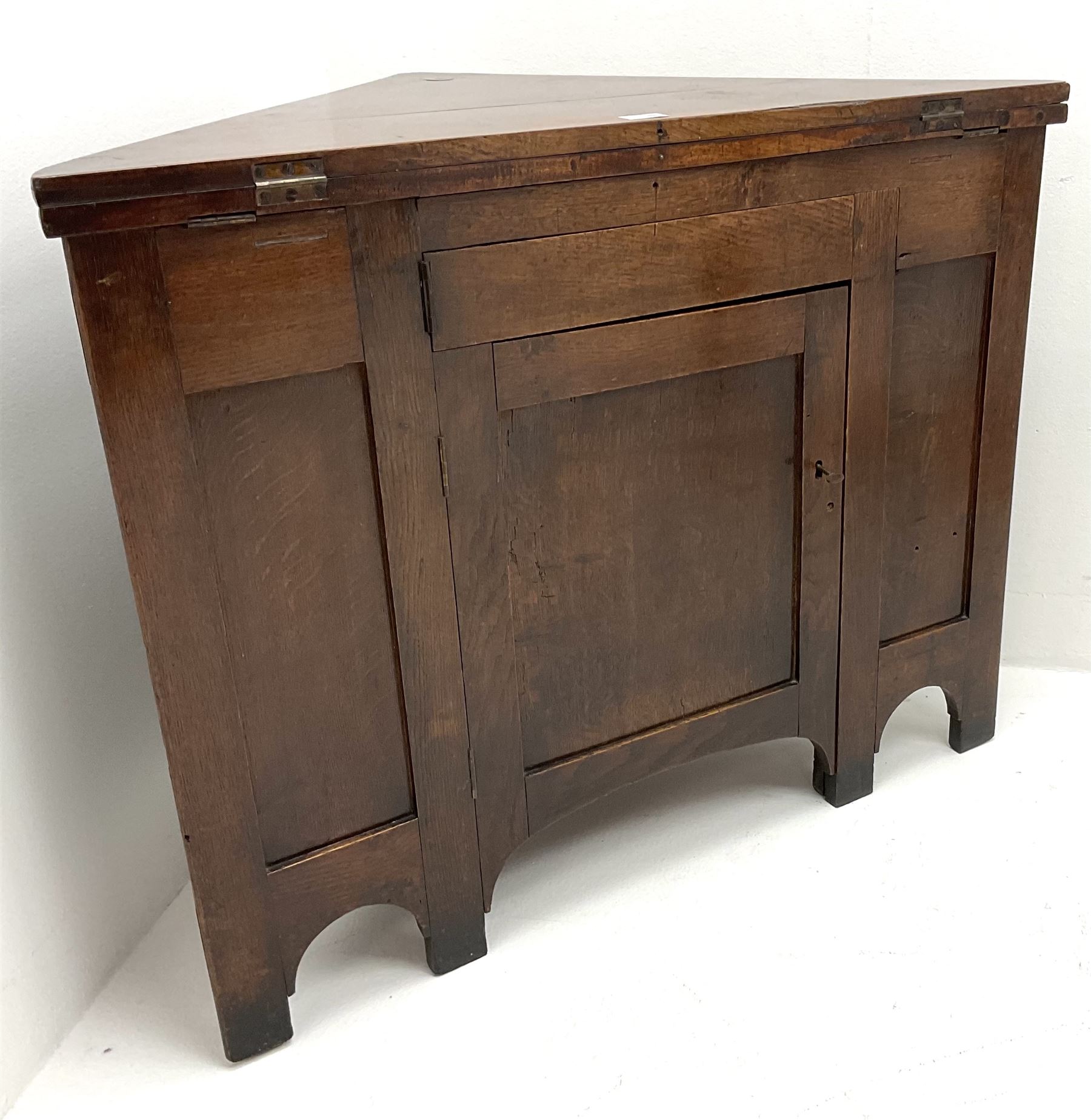 George III oak and mahogany corner campaign desk, single cupboard, folding top enclosing inset leather writing pad
