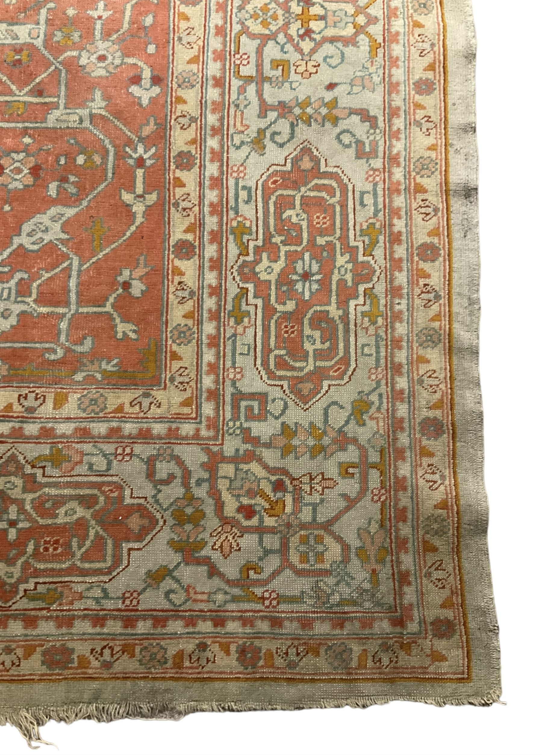 Large Persian pale sage ground carpet, the field decorated with central geometric medallion and tree of life motifs, the border with repeating geometric design decorated with stylised plant motifs