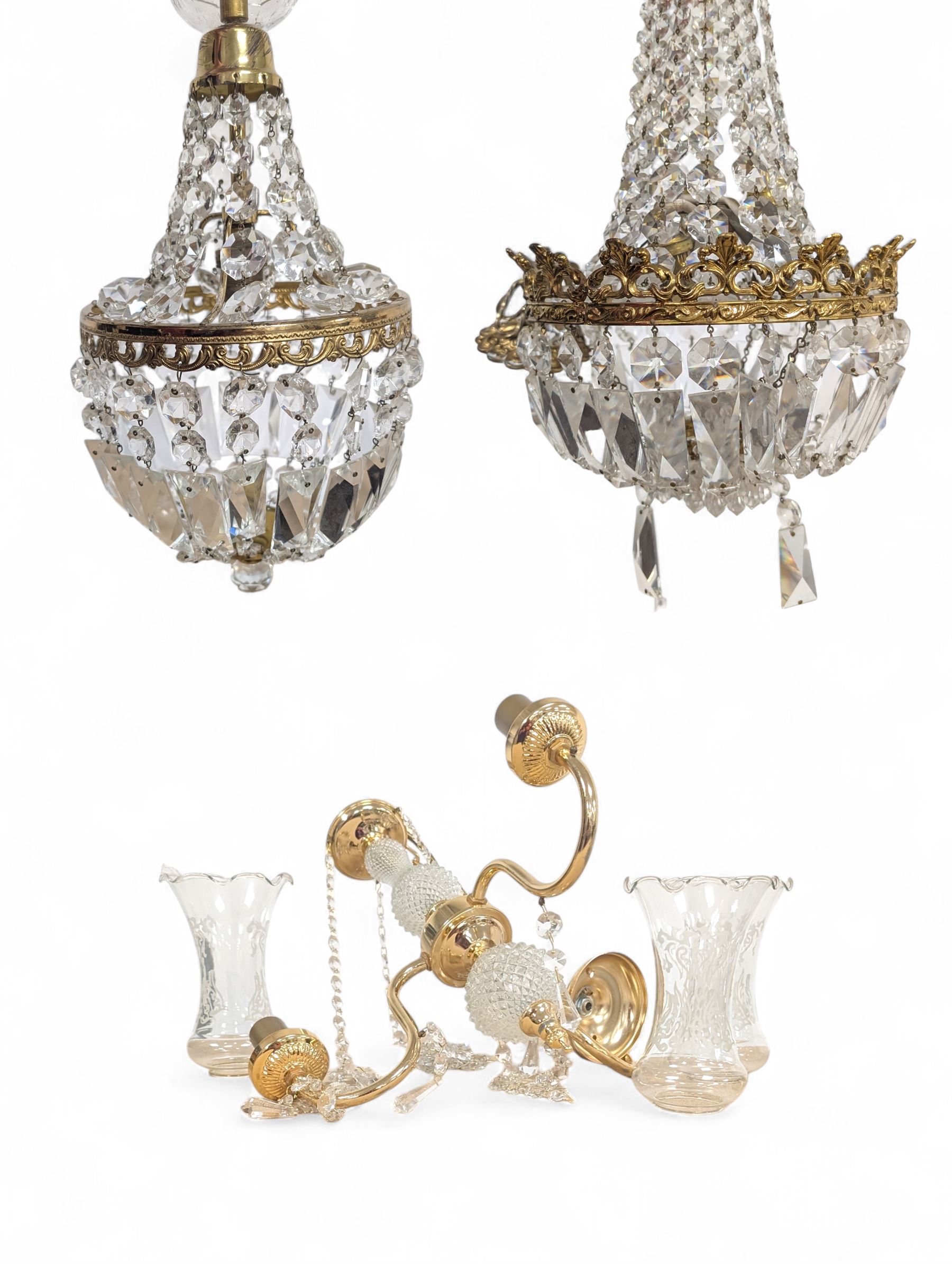 Two brass chandeliers with crystal drops, together with a brass and crystal three branch light fitting