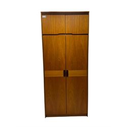 William Lawrence - mid-20th century teak double wardrobe, upper storage section over twin doors featuring recessed handles and contrasting horizontal panel, enclosing a hanging rail compartment, on plinth base with concealed castors