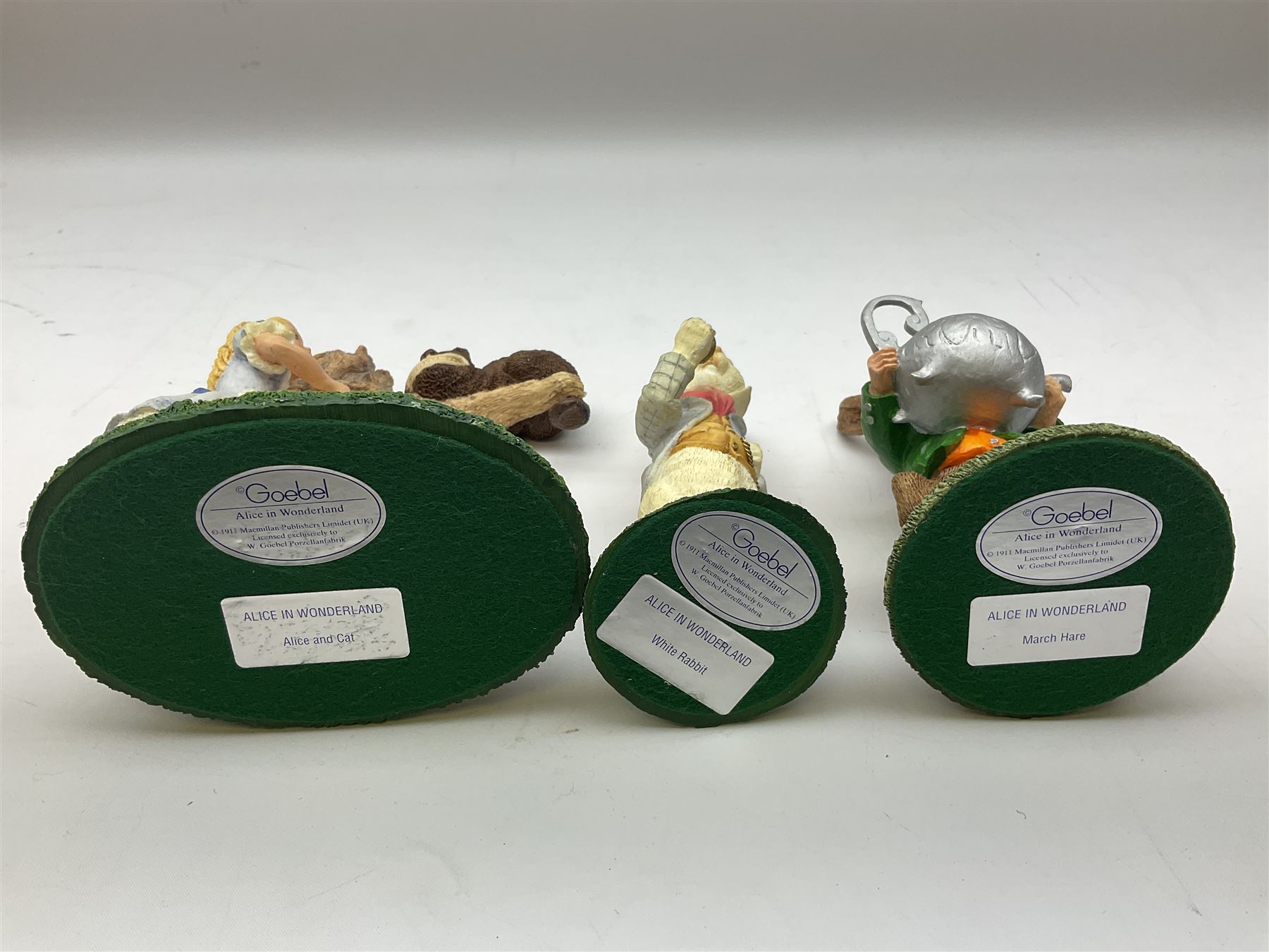 Goebel Alice in Wonderland figures, comprising Alice and Cat, White Rabbit, Queen of Hearts, March Hare, Tweedle Dee and the Mock Turtle, largest H18cm