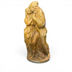 Composite garden statue group of Romeo and Juliet embracing in Medieval dress, surmounted on a naturalistic foliate base, in antique distressed glazed finish