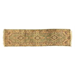 Pair of Bangladeshi olive ground runner rugs, machine-made with 100% jute pile, each with three central diamond-shaped medallions with intricate floral motifs, the field decorated with scrolling floral designs, bordered by stylised floral patterns 