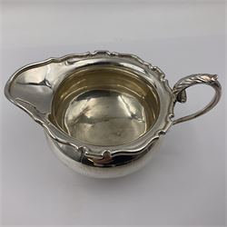 1920s five-piece silver tea service, comprising teapot, coffee pot, hot water pot, twin handled open sucrier and milk jug, each of squat circular form with shaped rim, the teapot, coffee pot and hot water pot each with ebonised handle and finial, the sucrier and milk jug with acanthus capped scroll handles, all upon circular foot, hallmarked R F Mosley & Co, Sheffield 1926 & 1927, tallest H24cm