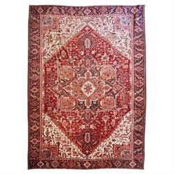 North West Persian Heriz hand-knotted carpet, brick red field with a large central angular...