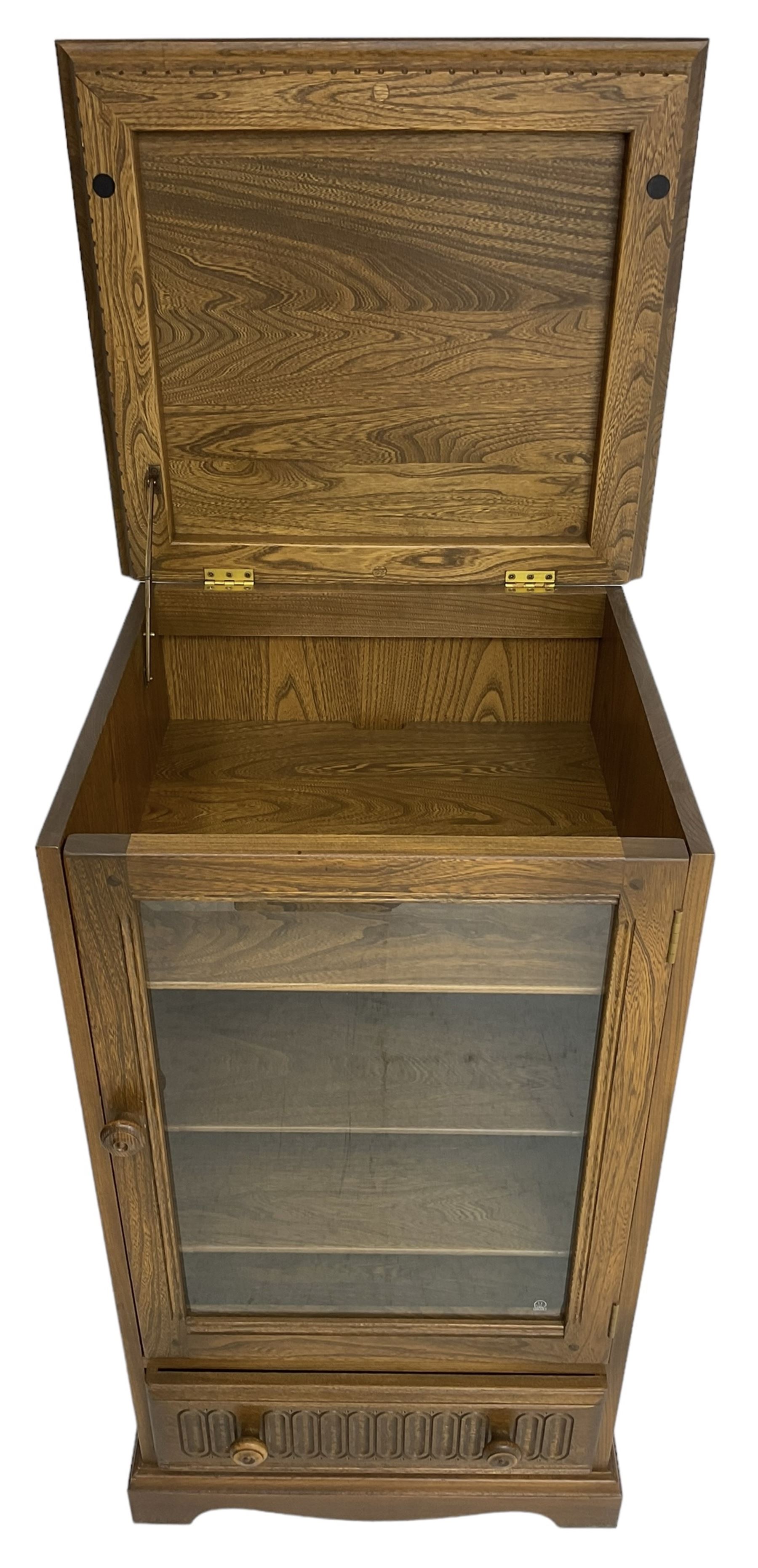 Ercol - mid-20th century dark elm 'Old Colonial' music cabinet, single glazed door enclosing three shelves, single drawer fitted to base