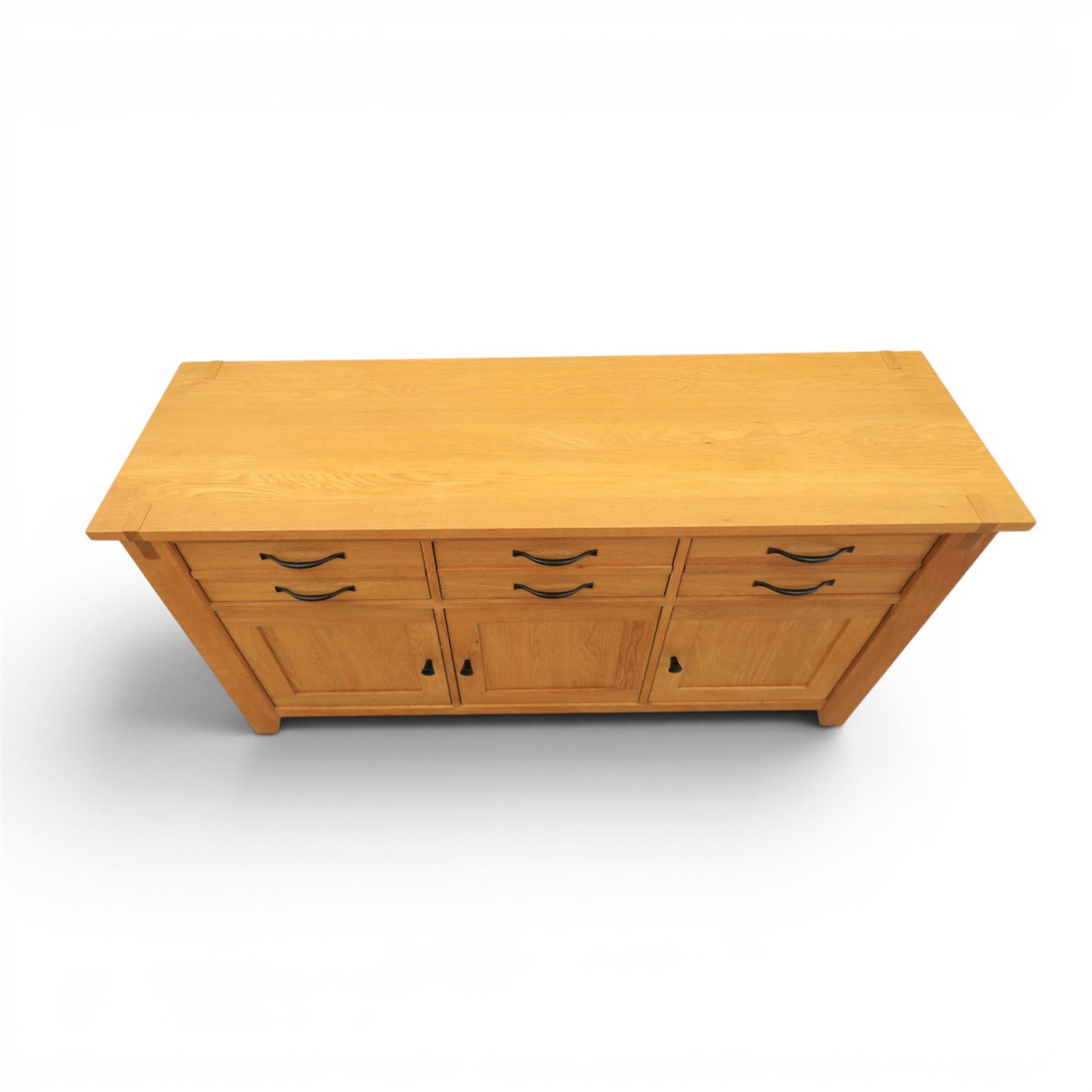 Contemporary Oak sideboard, rectangular top with tenon detailing, three drawers over three cupboard doors, blackened metal handles, raised on square supports