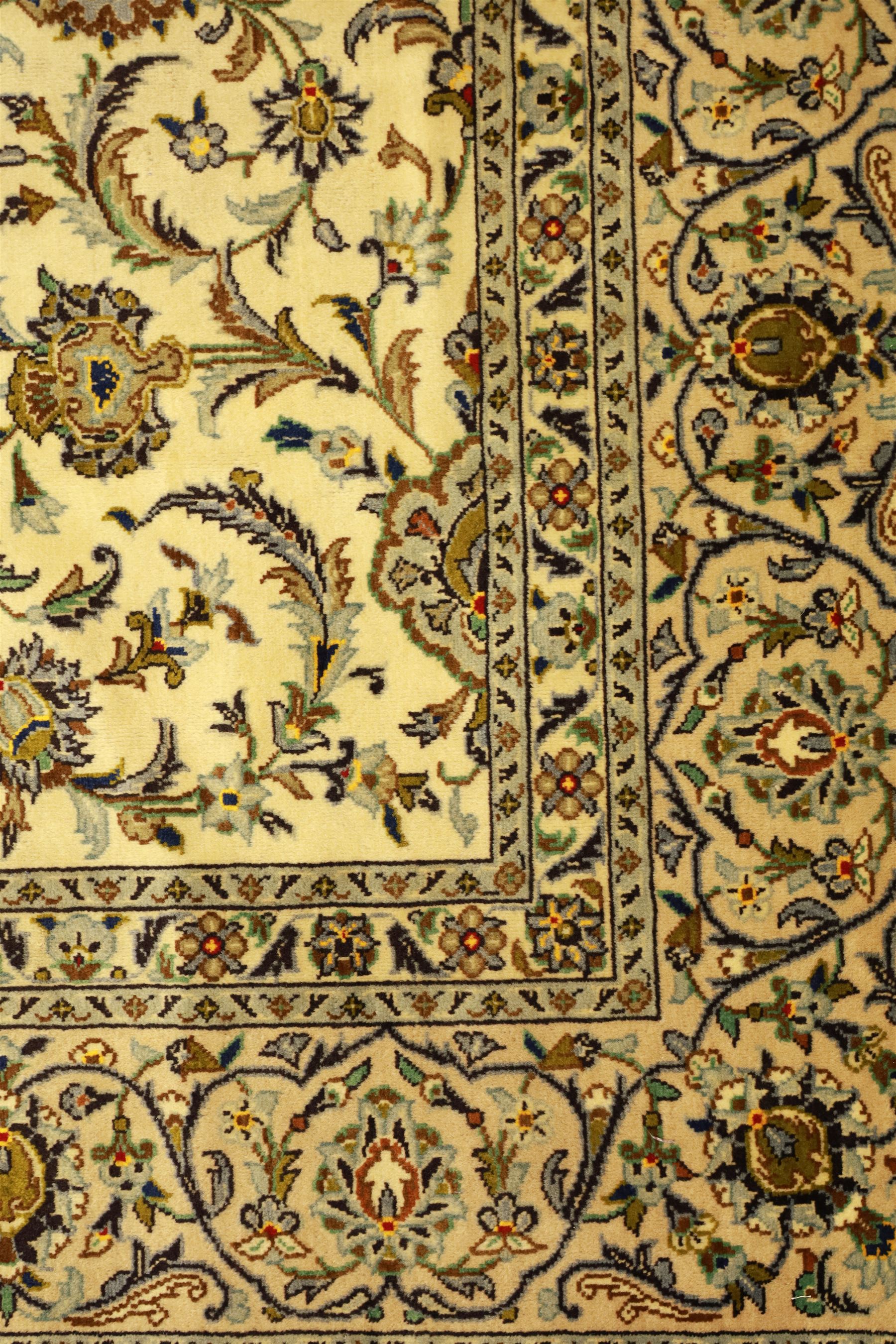 Central Persian Kashan carpet, ivory ground, field with an all-over design of scrolling palmettes and floral sprays in blue and terracotta within a beige ground and pale blue floral border