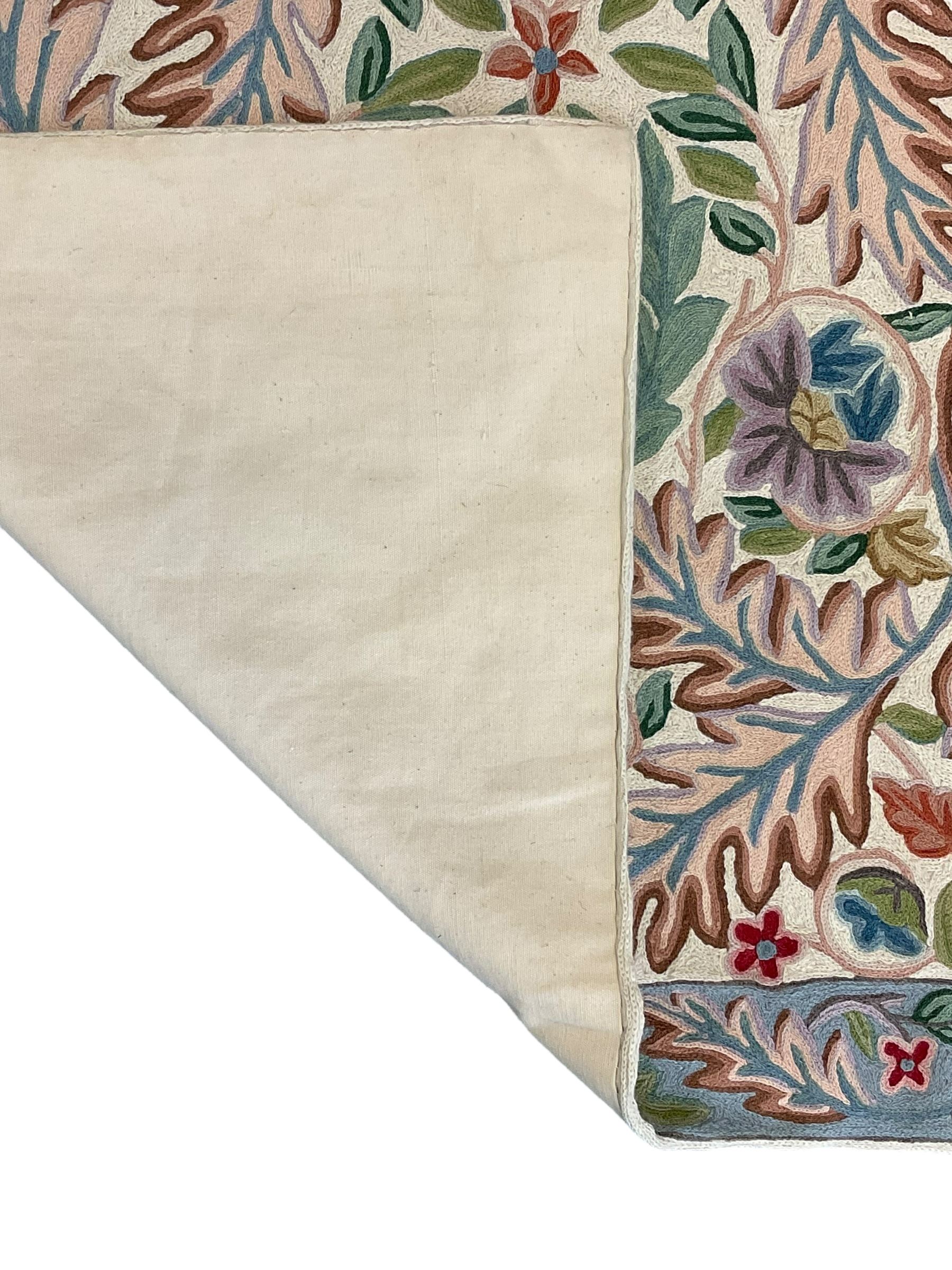 Crewel work wool chain wall hanging or rug, decorated with leaves and flower heads, the border with trailing floral pattern