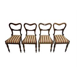 Set four late 19th century rosewood dining chairs, the balloon backs with scroll carved centre rail over upholstered drop-in seats, raised on tapered lappit carved supports