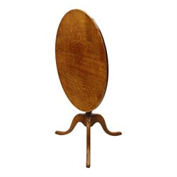 Traditional design golden oak tilt-top tripod table, brass fittings, turned baluster column on splayed supports