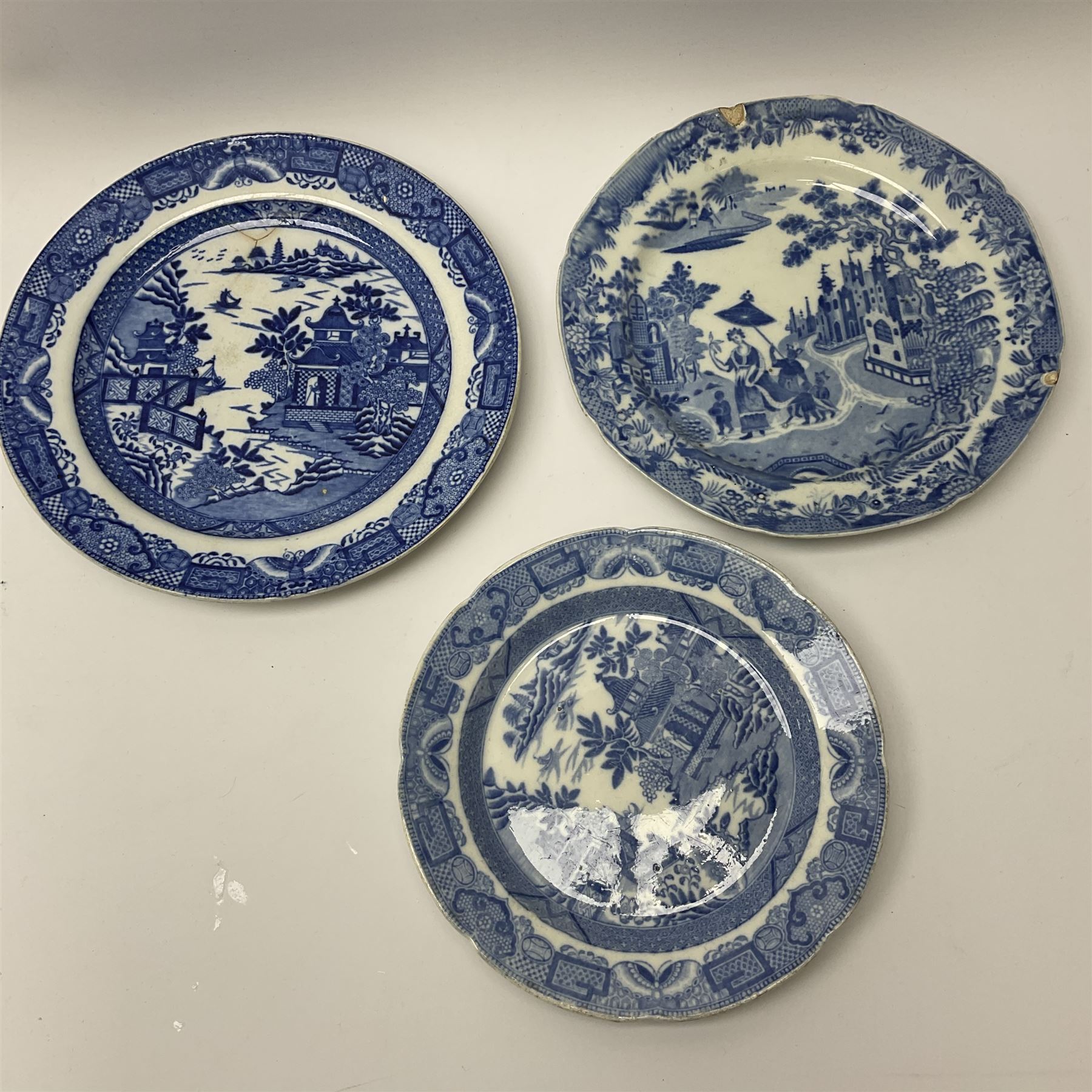 A group of 19th century blue and white transfer printed pottery, various makers and patterns, to include Minton Queen of Sheba pattern plate, Joshua Heath Reindeer pattern plate with towering pagoda, and seal in the foreground, a number of plates decorated in the Chinoiserie Bridgeless pattern, two Mandarin type pattern plates, possibly Spode, etc. 