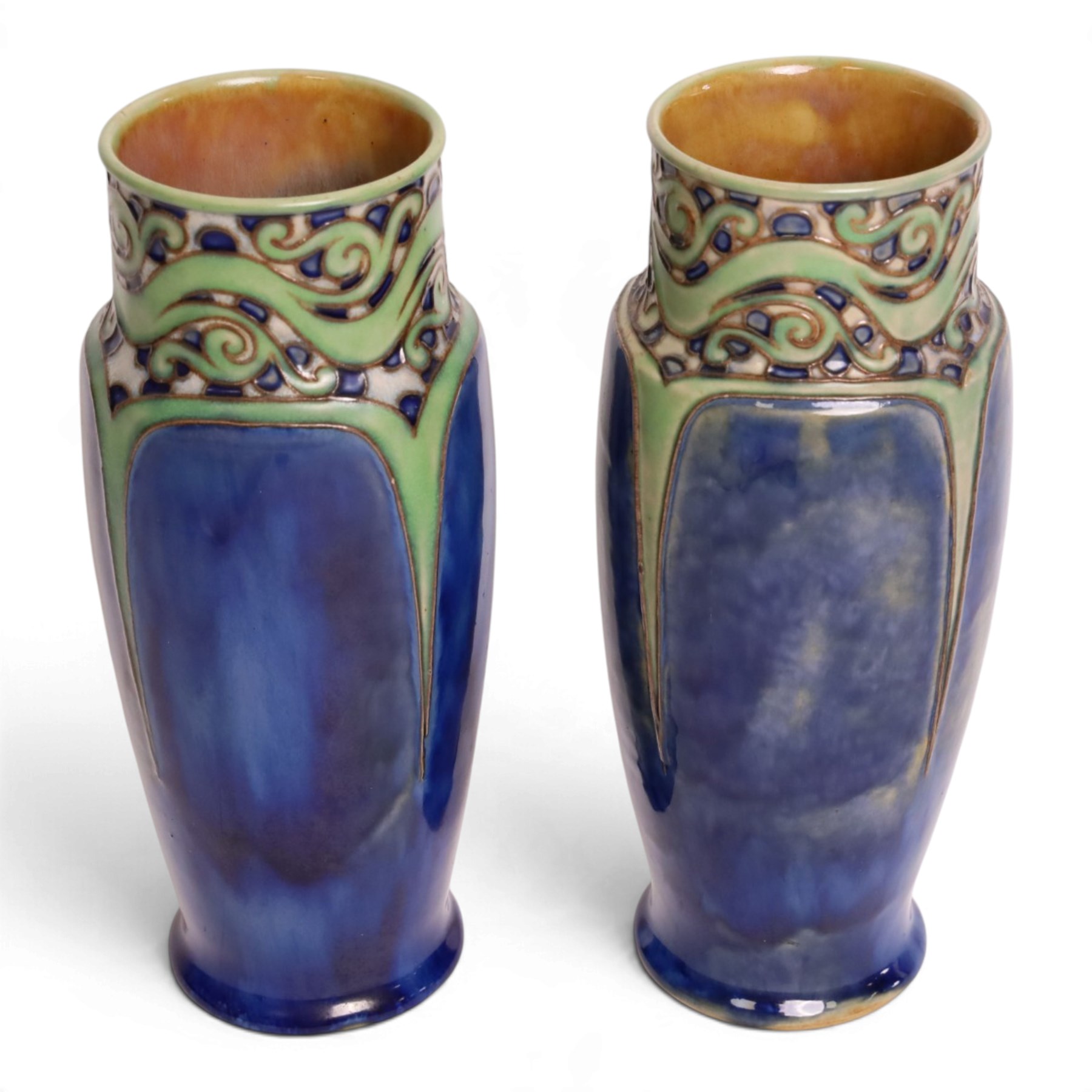 Royal Doulton - Pair of Art Nouveau vases, designed by Francis Pope, with scroll work to the collar, in tones of green and blue, with impressed mark and no. 8138 beneath, H26cm