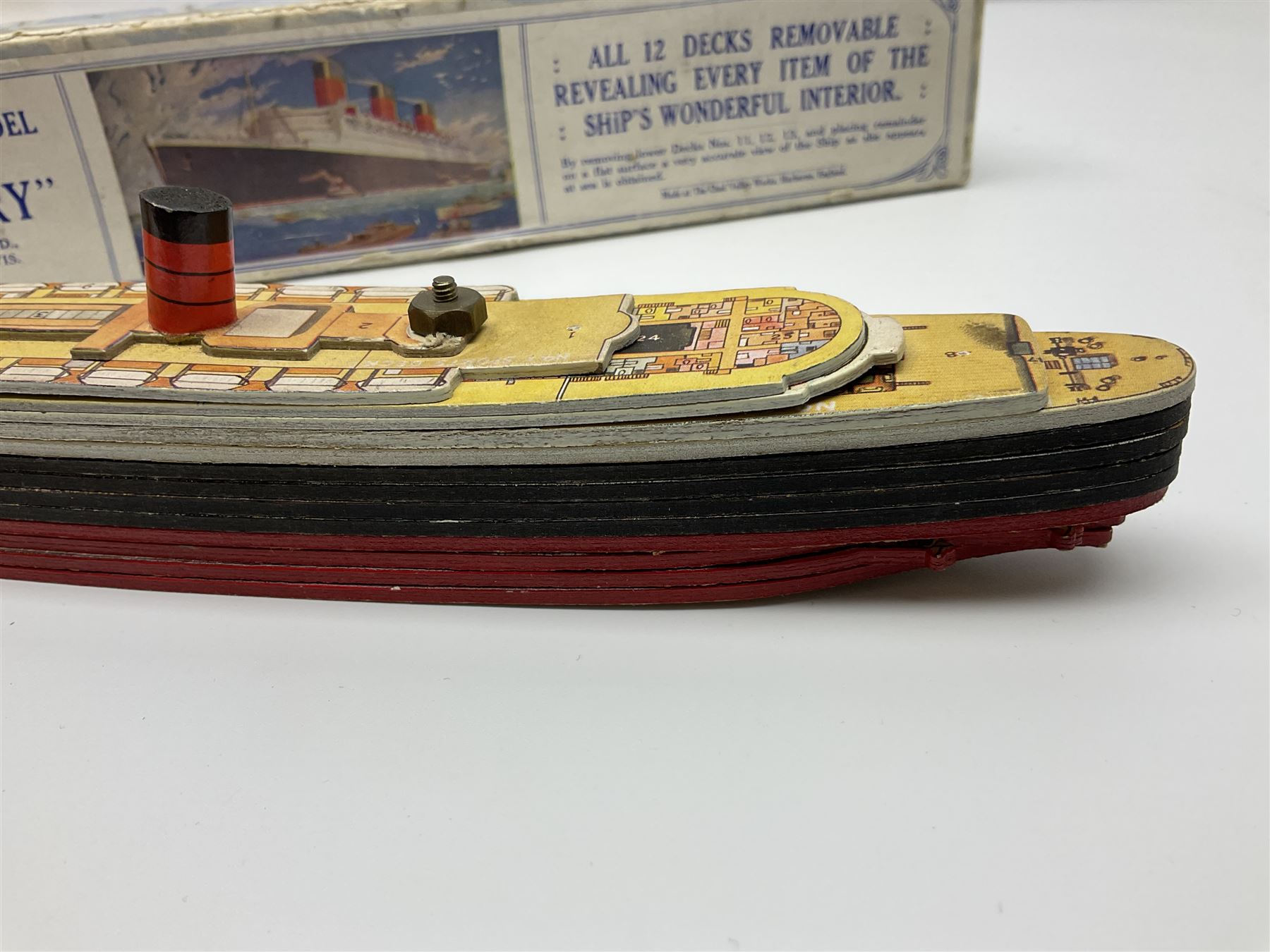 Chad Valley 'Take to Pieces' model of R.M.S. Queen Mary; made up of thirteen removable decks revealing the interior, held together by nuts/bolts to the top deck; boxed with original key chart sheet